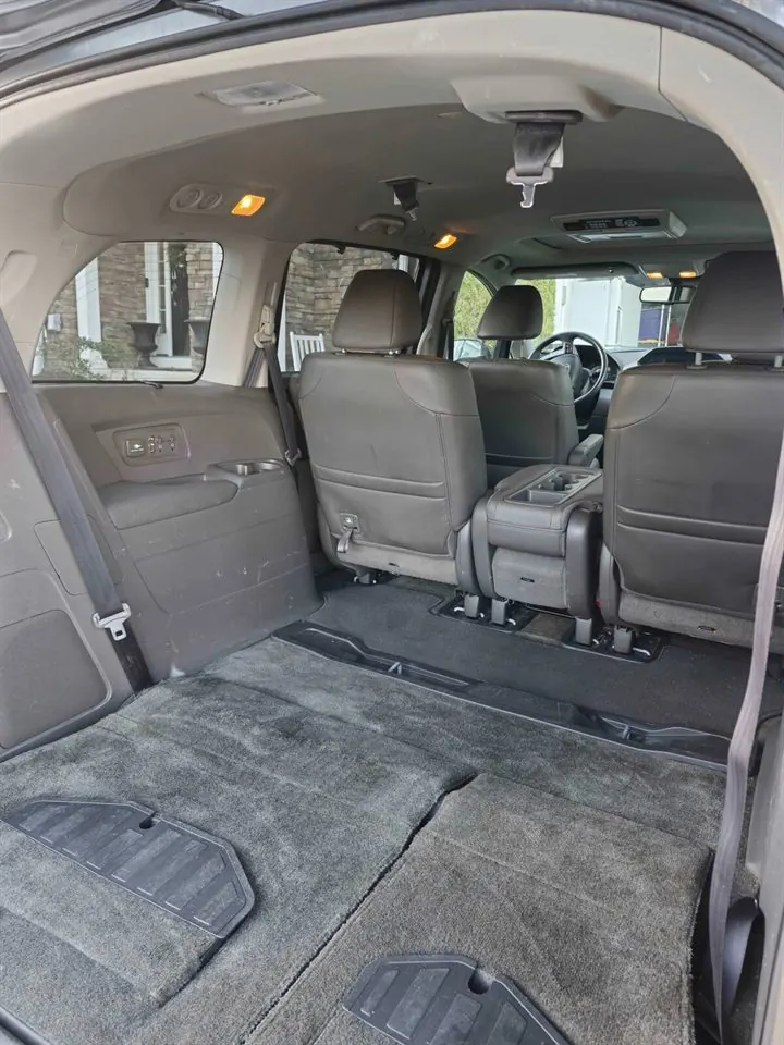 Minivan cargo area after detailing — carpet and trim freshly cleaned
