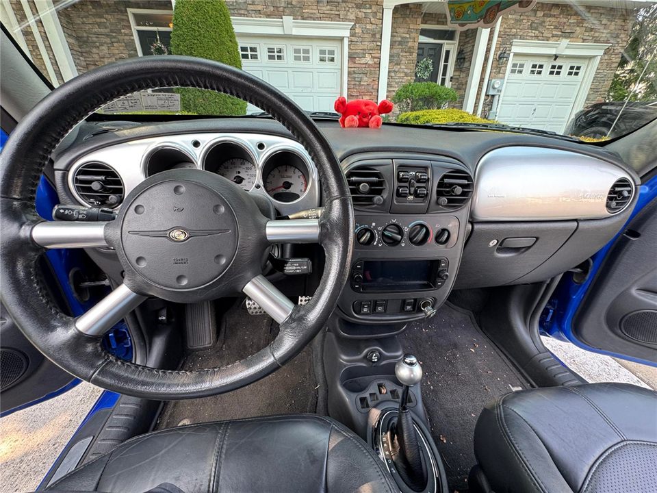 Dashboard and center console before detailing — dust on trim and debris on the floor