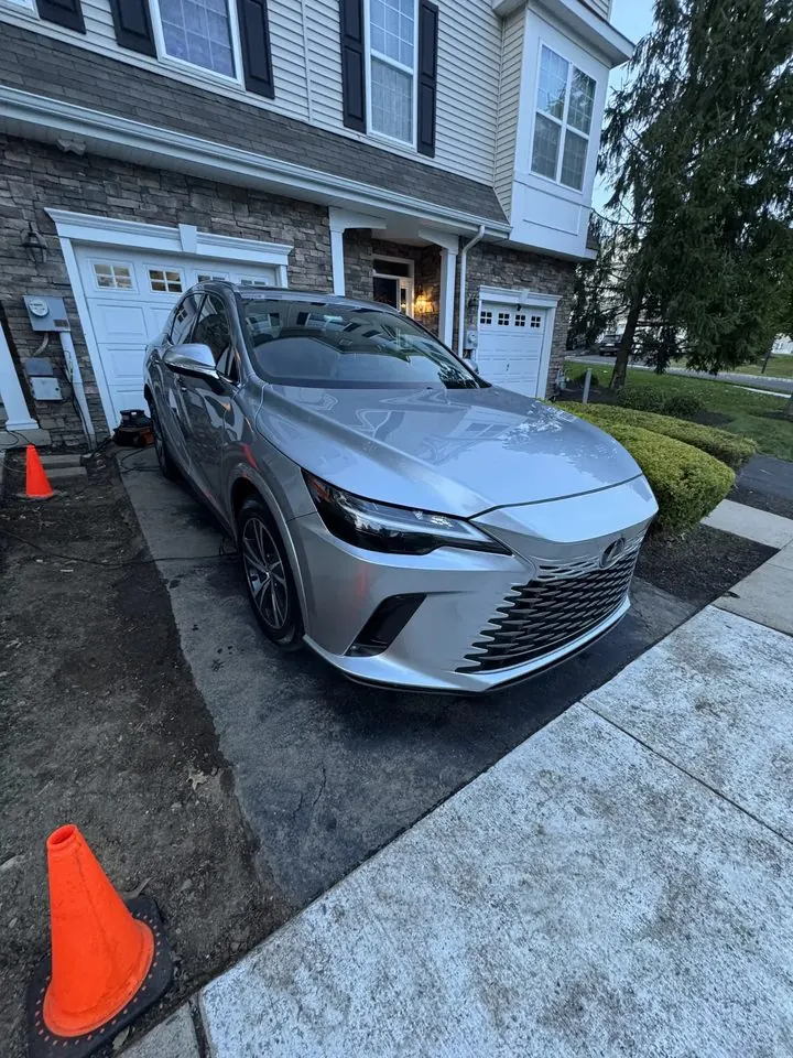Silver Lexus RX after an exterior detail — deep gloss with the house reflected in the hood
