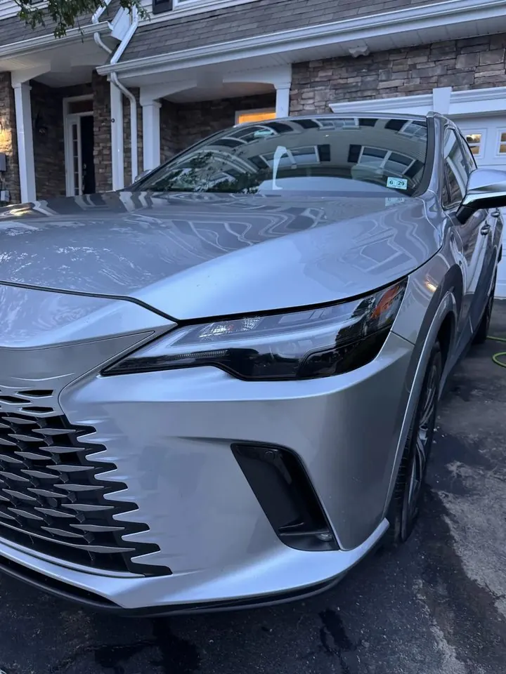 Lexus headlight and front bumper after an exterior detail, paint clean and glossy