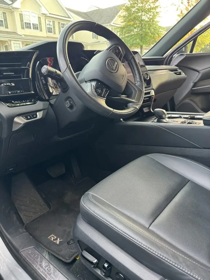 Driver seat and footwell before detailing — dusty trim and dirty floor mat