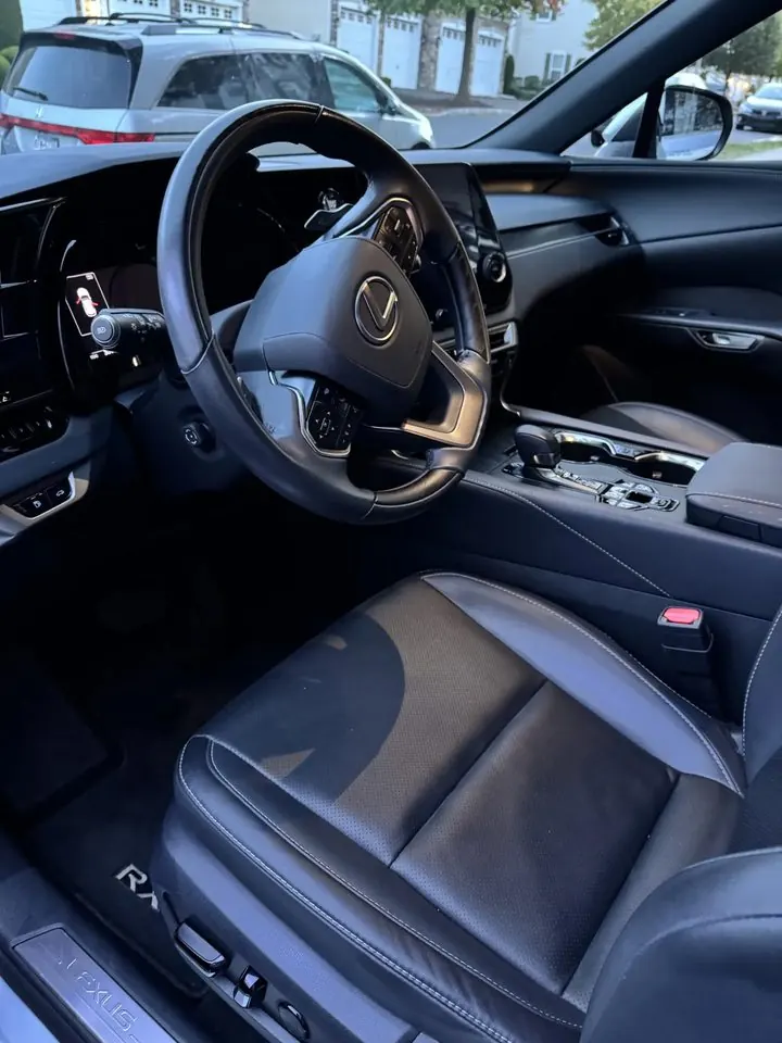 Driver seat and dash after detailing — leather and trim clean, floor mat vacuumed